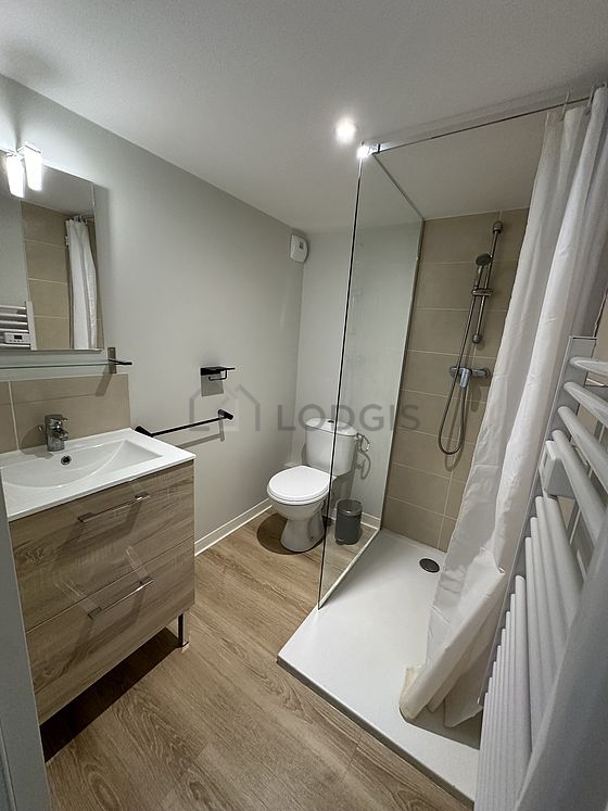 Pleasant and very bright bathroom with wooden floor