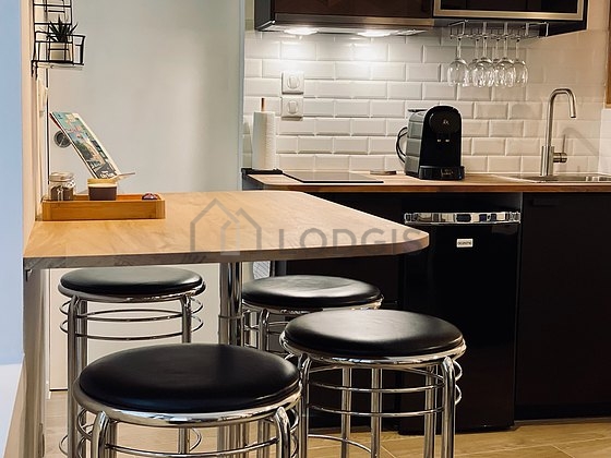 Kitchen equipped with washing machine, refrigerator, crockery, stool