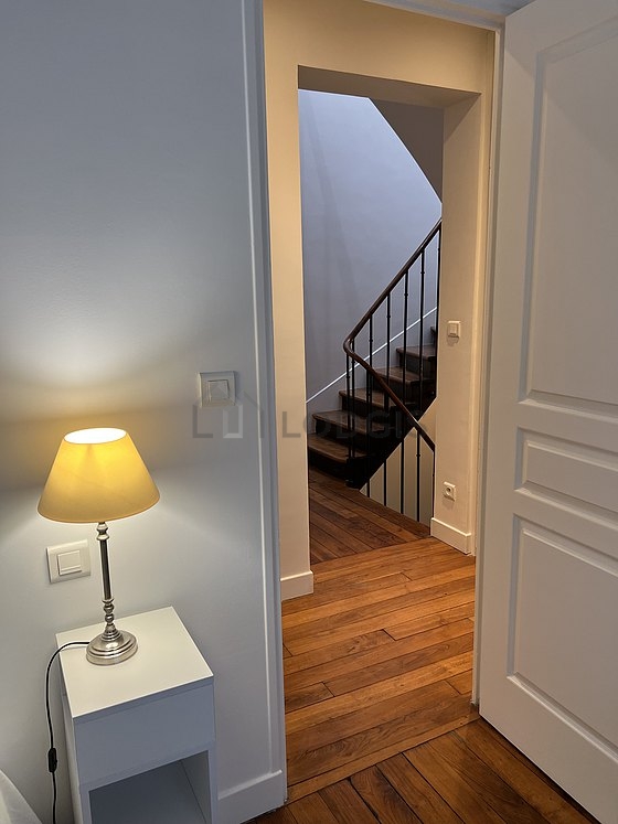 Bright bedroom equipped with storage space, cupboard, bedside table