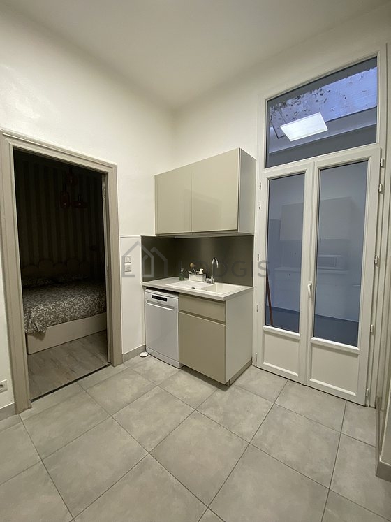 Kitchen equipped with dishwasher, refrigerator, crockery