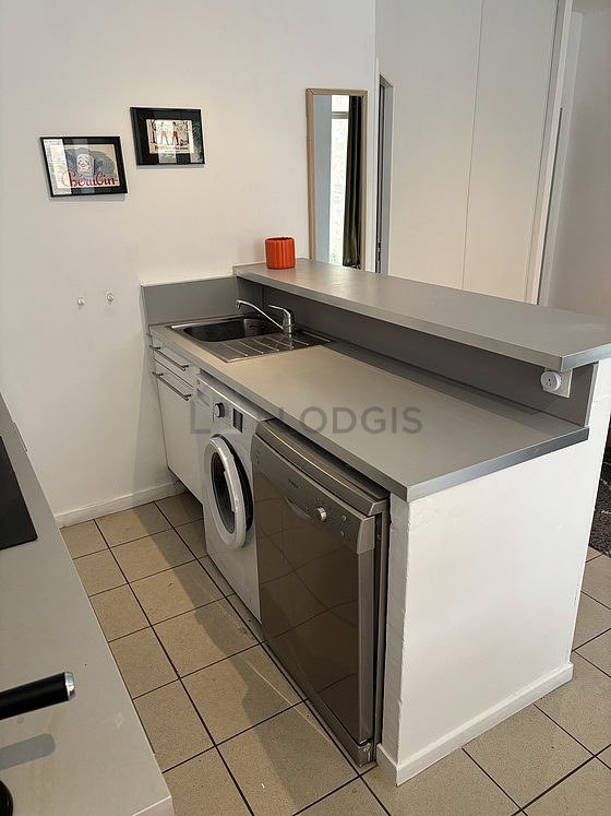Kitchen equipped with washing machine, refrigerator