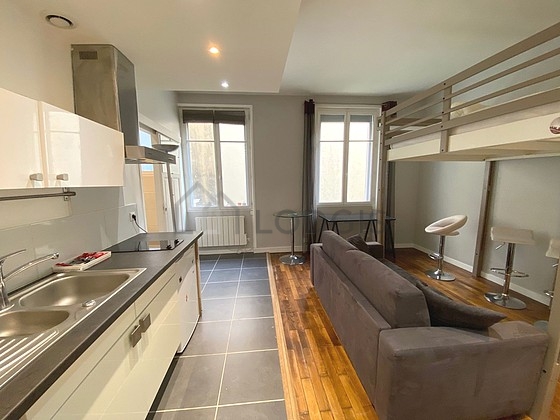 Kitchen equipped with hob, refrigerator, extractor hood