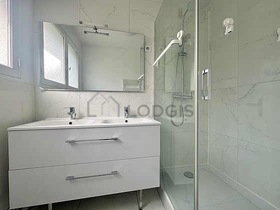 Bathroom equipped with washing machine, separate shower