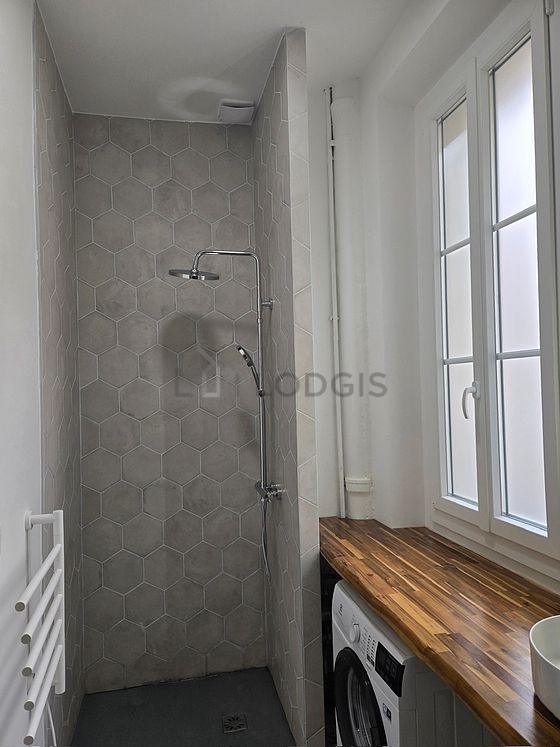 Bathroom equipped with washing machine, separate shower, hair-dryer
