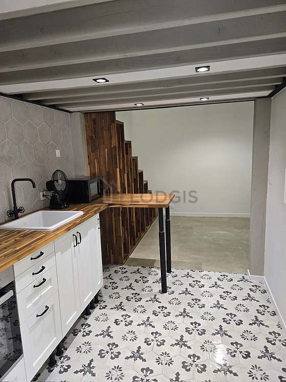 Kitchen equipped with hob, refrigerator