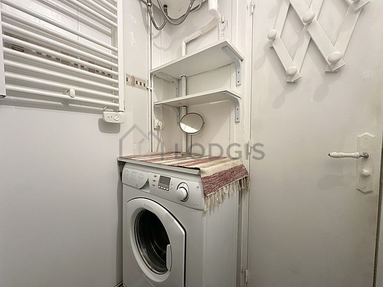 Bathroom equipped with washing machine, separate shower, towel drying radiator
