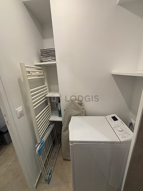 Bathroom equipped with washing machine, cupboard