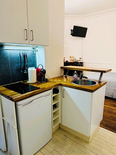 Kitchen equipped with hob, refrigerator, crockery