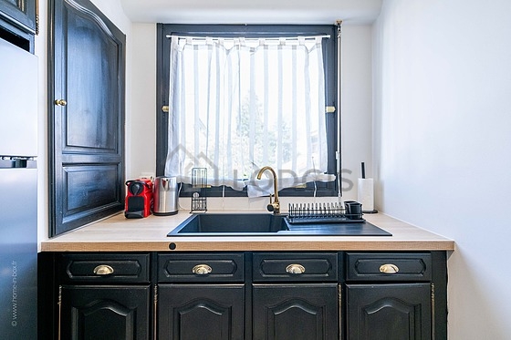 Kitchen equipped with washing machine, refrigerator, freezer