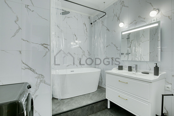 Bathroom equipped with washing machine, dryer, hair-dryer
