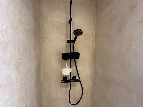 Salle de bain équipée de douche séparée, radiateur sèche-serviettes