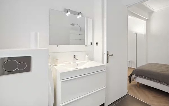 Bathroom equipped with washing machine, dryer, shower in bath tub