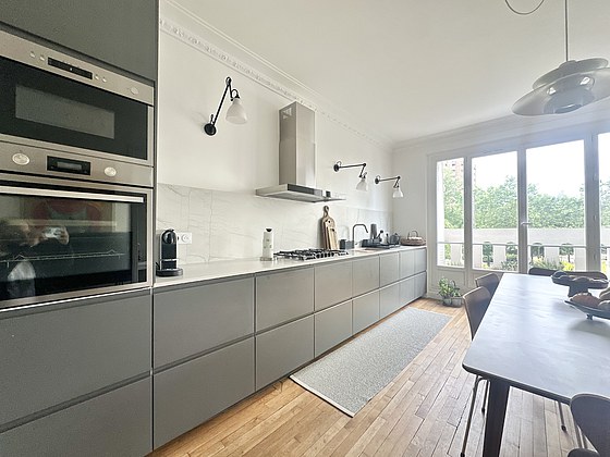 Beautiful kitchenopens on the dining room with wooden floor