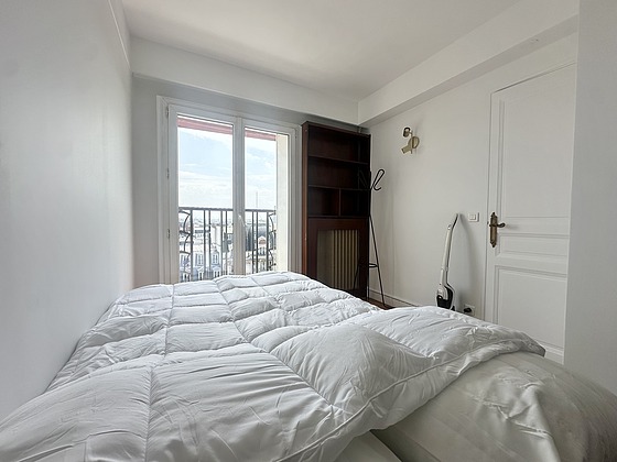 Bright bedroom equipped with cupboard