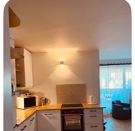 Kitchen equipped with dishwasher, hob, refrigerator, crockery
