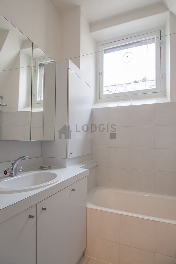 Beautiful and bright bathroom with windows and with tile floor