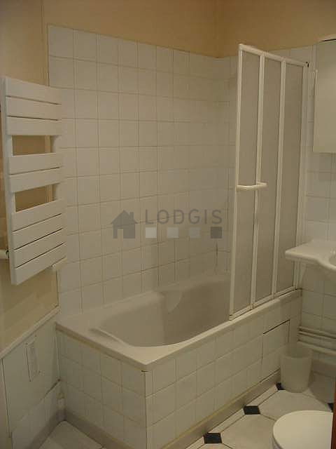 Bathroom equipped with shelves, electric toilet