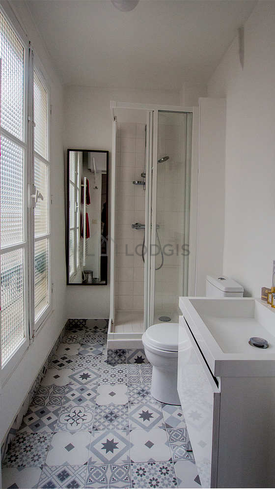 Salle de bain claire avec fenêtres et du carrelage au sol