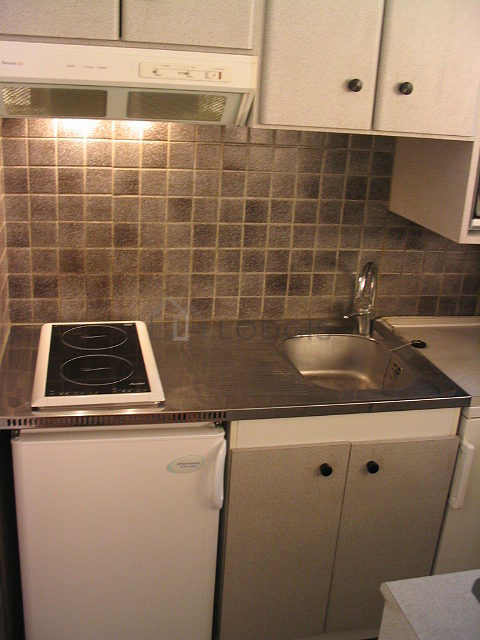 Kitchen equipped with hob, refrigerator, crockery