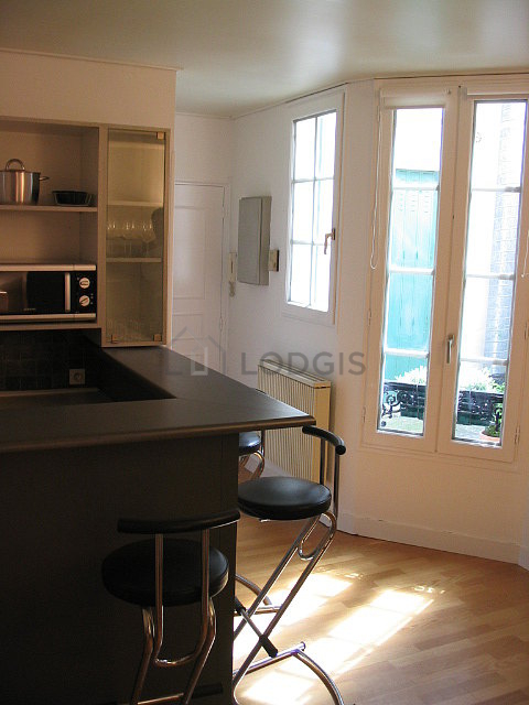 Living room with windows facing the courtyard