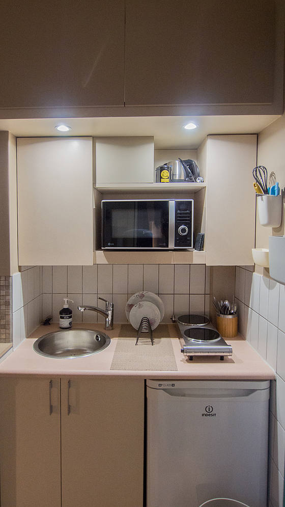 Kitchen equipped with crockery, stool