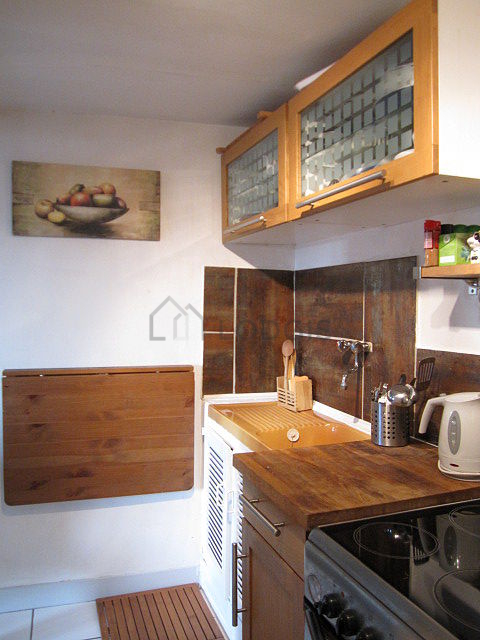 Kitchen equipped with hob, refrigerator, crockery