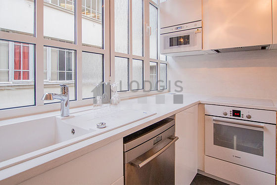 Kitchen equipped with dishwasher, hob, refrigerator, extractor hood