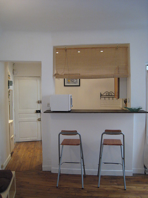 Beautiful kitchenopens on the living room with tile floor