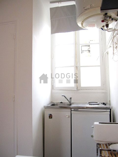 Kitchen equipped with hob, refrigerator, freezer, crockery