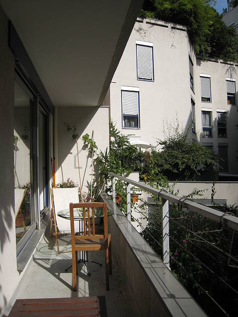 Living room with windows and balcony facing the garden