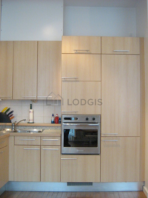 Kitchen equipped with dishwasher, hob, refrigerator, extractor hood