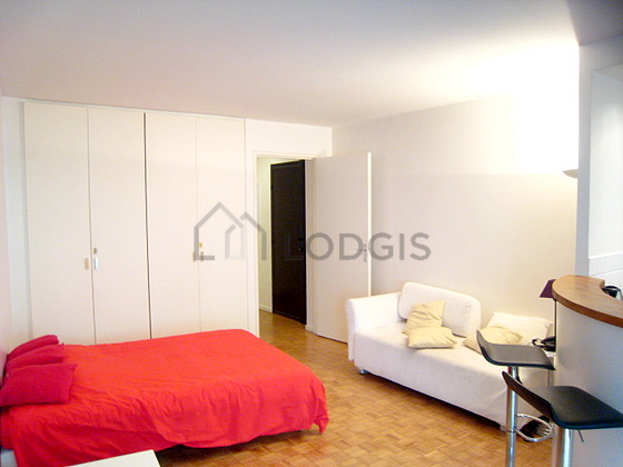 Bright living room furnished with cupboard, 2 chair(s)