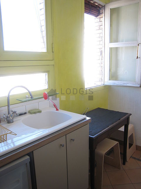Bright kitchen with double-glazed windows facing the courtyard