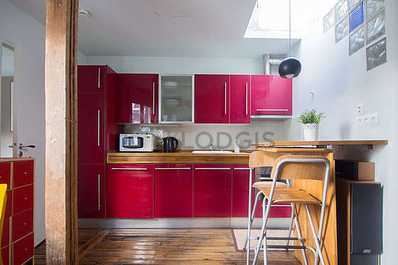 Kitchen equipped with crockery, stool