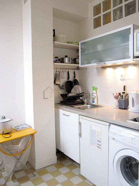 Kitchen equipped with washing machine, refrigerator, freezer, crockery