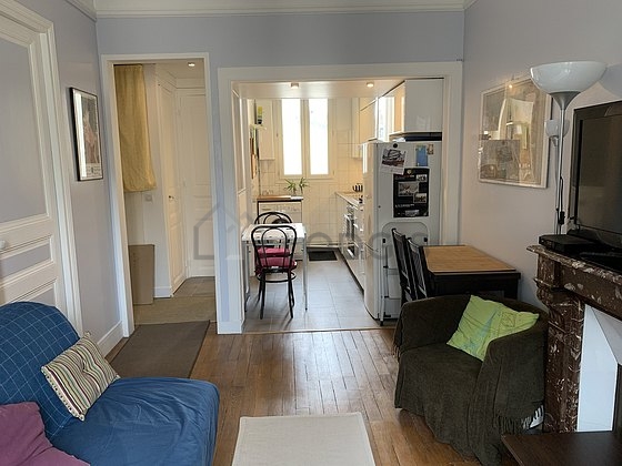 Kitchenopens on the living room with tile floor