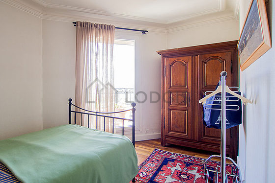 Bedroom with double-glazed windows and balcony facing the road
