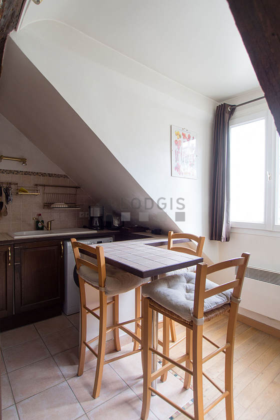 Beautiful kitchenopens on the living room with tile floor