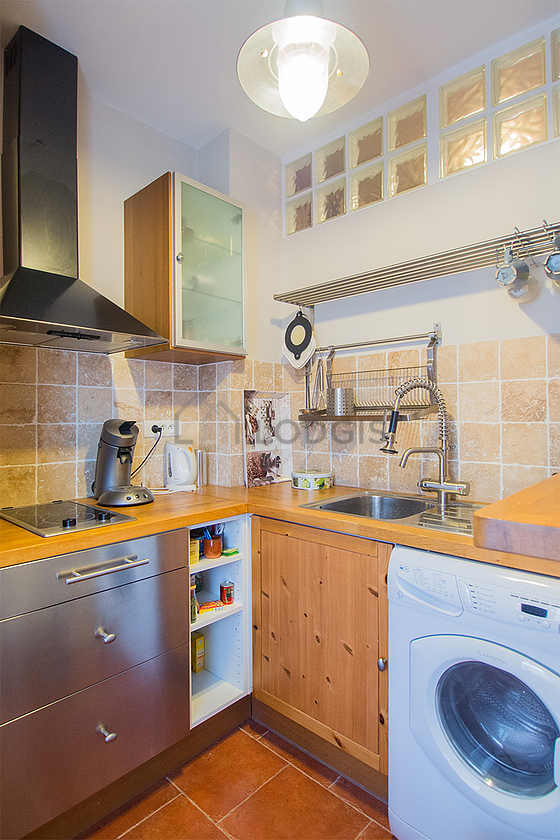 Kitchen equipped with washing machine, dryer, refrigerator, extractor hood
