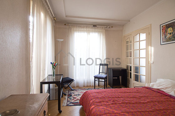 Bedroom with windows facing the road