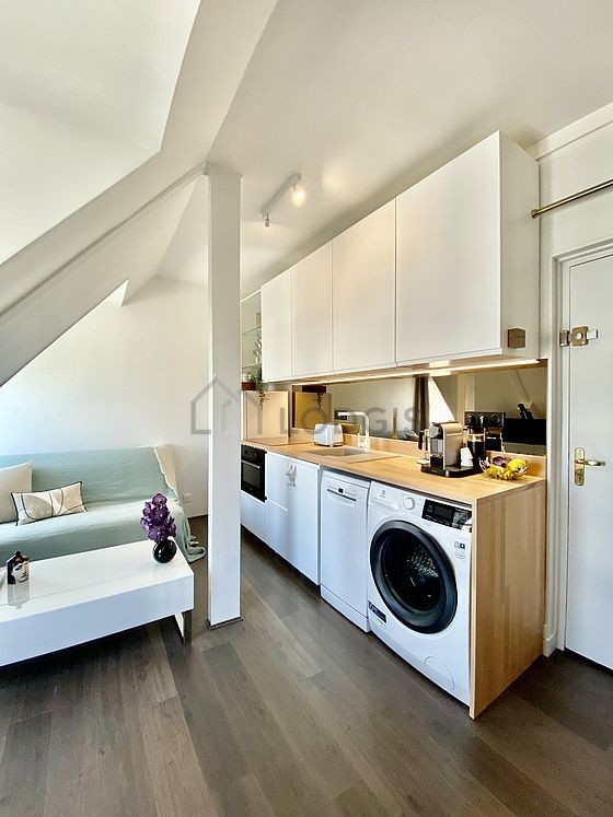 Beautiful kitchenopens on the living room with wooden floor