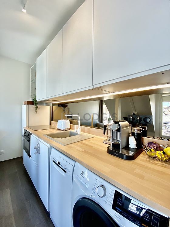 Kitchen equipped with dishwasher, hob, refrigerator, extractor hood