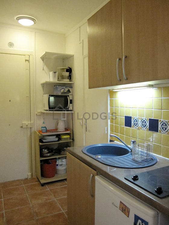 Kitchen equipped with hob, refrigerator, crockery