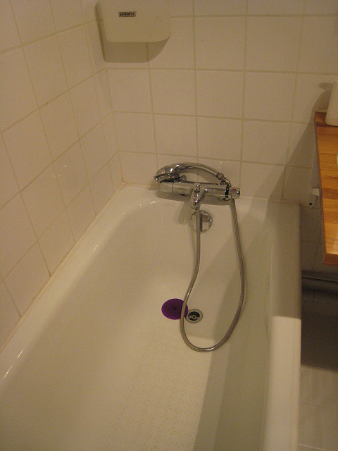 Bathroom equipped with washing machine, dryer, bath towels