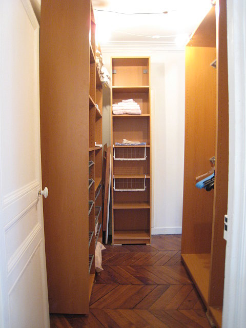 Quiet walk-in closet with wooden floor