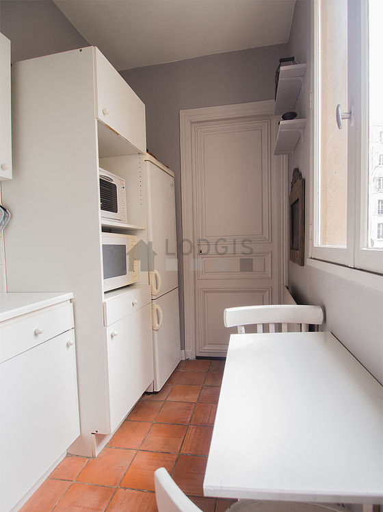 Kitchen equipped with dishwasher, hob, refrigerator, extractor hood