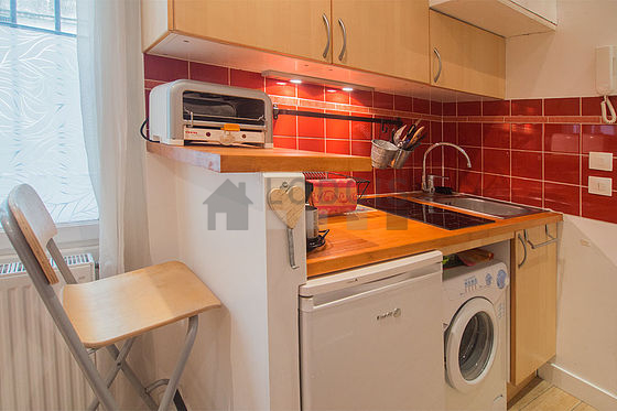 Kitchen equipped with washing machine, refrigerator, freezer, crockery
