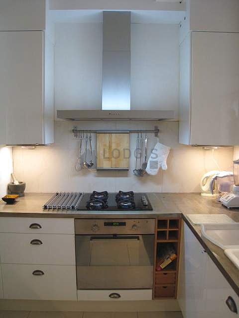 Kitchen equipped with washing machine, refrigerator, extractor hood, crockery