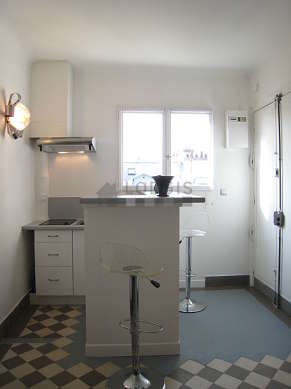 Kitchen where you can have dinner for 2 person(s) equipped with hob, refrigerator, freezer, extractor hood