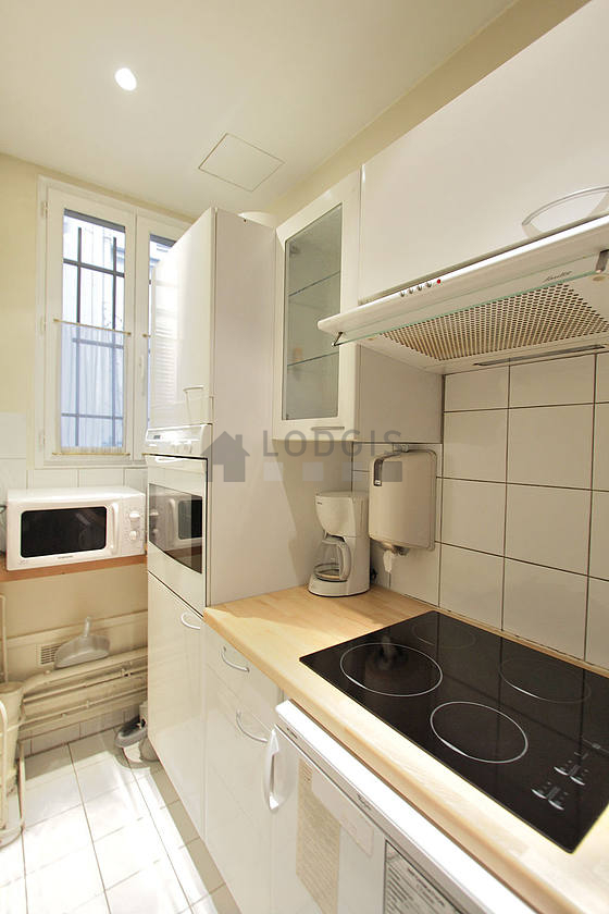 Kitchen where you can have dinner for 2 person(s) equipped with hob, refrigerator, freezer, extractor hood